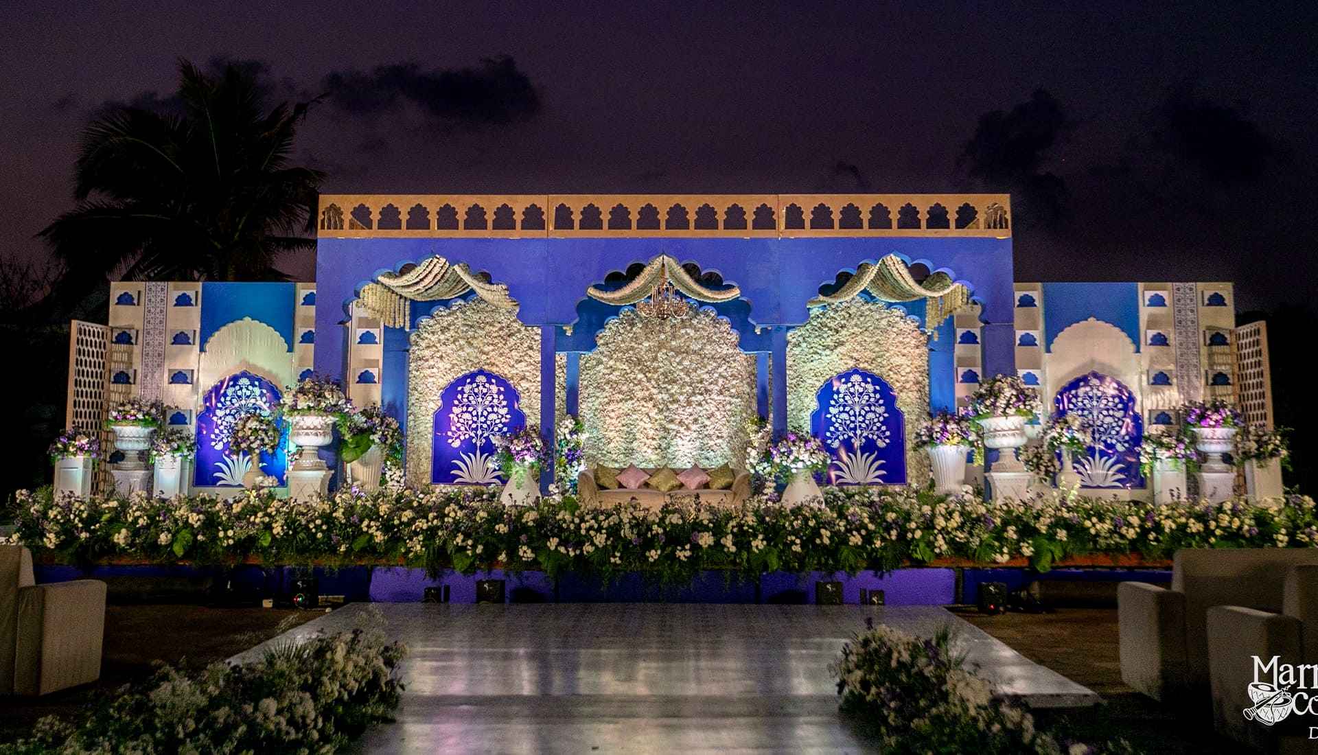 Luxurious Indian wedding stage decoration at Taj Fisherman's Cove Kovalam with white and blue flowers