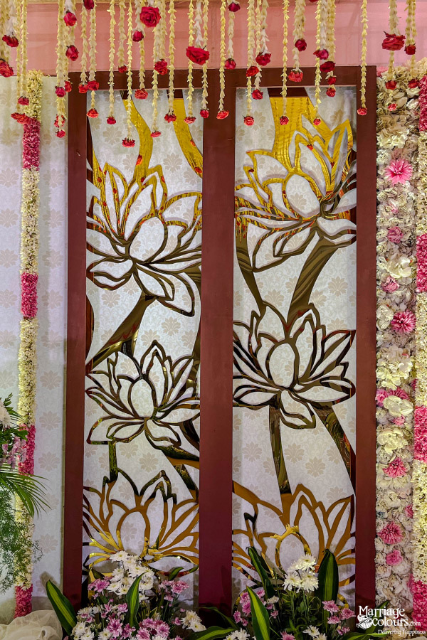Decorative wedding panel featuring large gold and white laser-cut lotus flower designs.