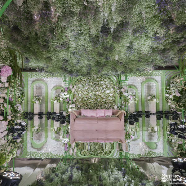 Gorgeous close-up view of an elaborately decorated wedding stage with a blush pink sofa.