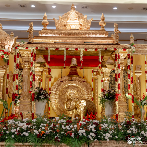 Highly detailed, ornate South Indian wedding stage featuring a golden elephant statue and floral border.