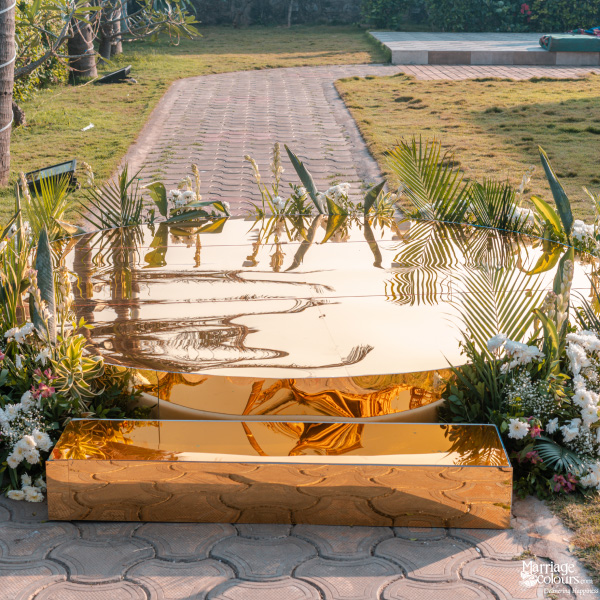 Unique outdoor ceremony platform featuring tiered, highly reflective gold mirror surfaces.
