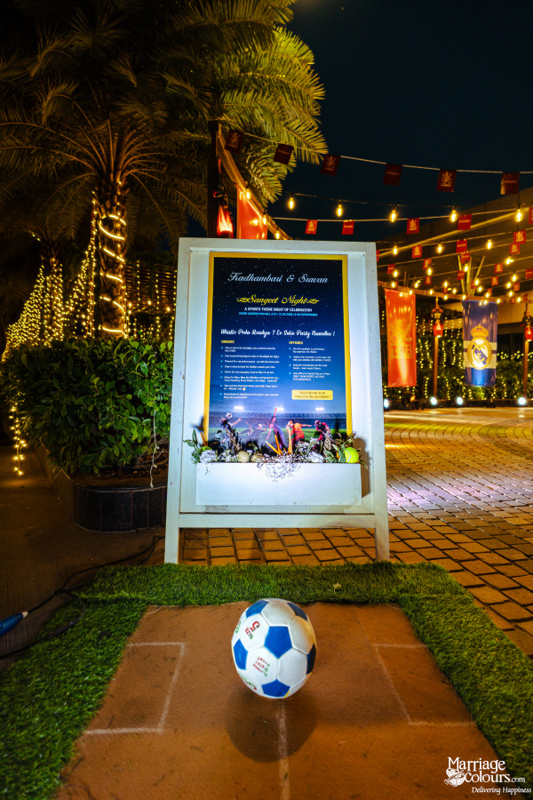 A large, lit sign detailing the "Sports Night" celebration, with a soccer ball in the foreground.