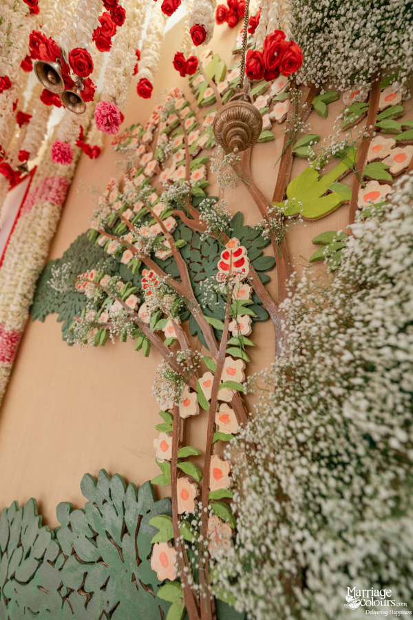A close-up of a whimsical wedding backdrop with a stylized, sculpted floral tree design.