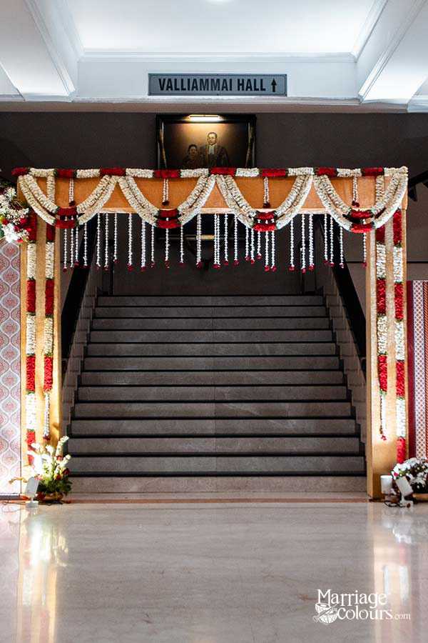 Decorated entrance to Valliammai Hall with floral garlands and a staircase