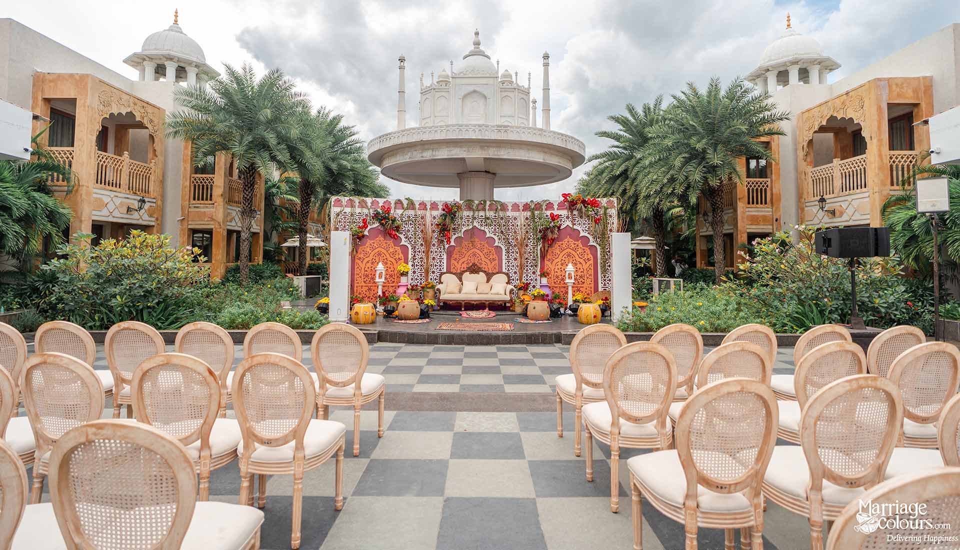 Mehndi stage decor with Mughal backdrop and floral accents at Kaldan Samudhra Palace Mahabalipuram