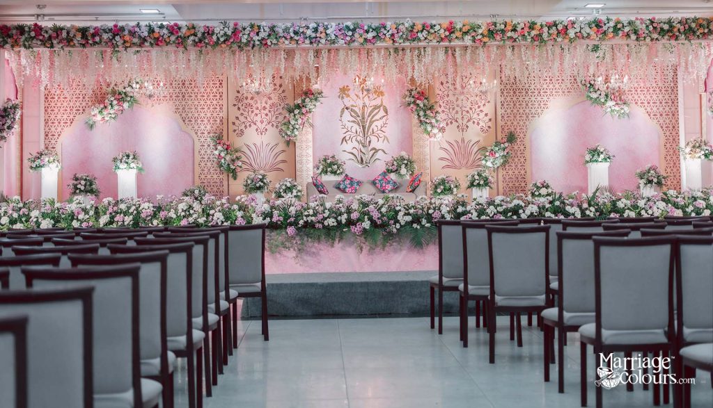 Pastel pink floral wedding stage with hanging flower garlands and decorative backdrop for a South Indian wedding ceremony in Chennai