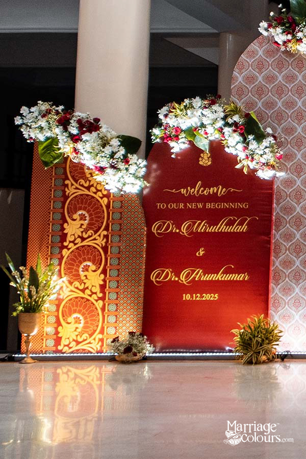 Red welcome sign for Dr. Mirudhulah & Dr. Arunkumar’s wedding on 10.12.2025