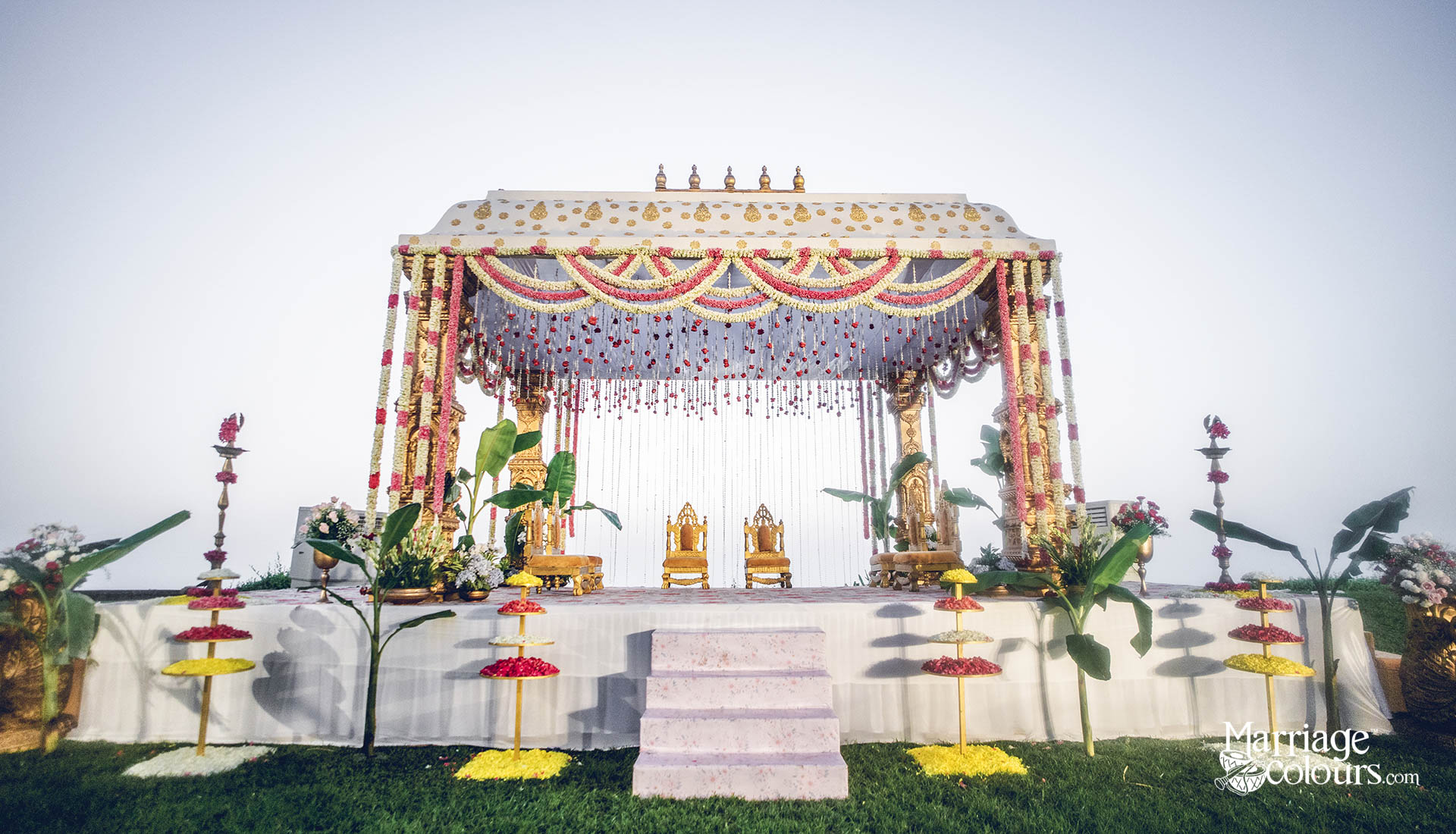 Traditional Telugu wedding mandap with floral garlands and golden pillars at Radisson Blu Resort Temple Bay Mamallapuram