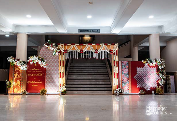 Grand wedding entrance decoration with floral garlands and traditional South Indian decor setup