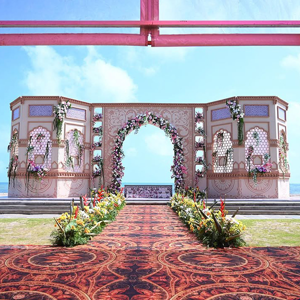 Luxury destination beach wedding setup by Mariage Colours at one of the best beach resorts in Mahabalipuram, featuring an oceanfront lawn venue with premium floral decor.