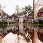 Eco friendly beach wedding décor by Mariage Colours featuring a sustainable mandap structure made of woven bamboo, local pampas grass, and potted palms on a coastal lawn.